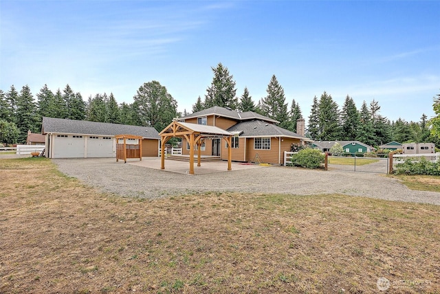 9321 339th St S Unit 5, Roy, WA 98580 - view of front of house featuring a gazebo, a patio, a detached garage, an outdoor structure, and a chimney