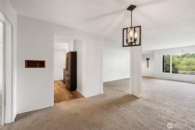 2220 91st St E, Tacoma, WA 98445 - unfurnished living room with light carpet, a chandelier, and a textured ceiling