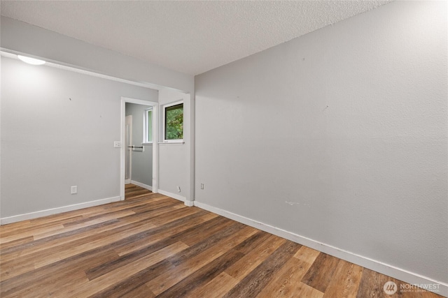 2220 91st St E, Tacoma, WA 98445 - spare room featuring wood finished floors and a textured ceiling