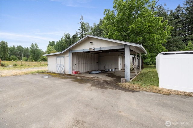 2220 91st St E, Tacoma, WA 98445 - garage with a detached garage and view of wooded area