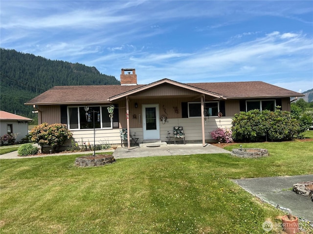 158 Skaggs Rd, Morton, WA 98356 - single story home with a chimney, a front yard, and a mountain view