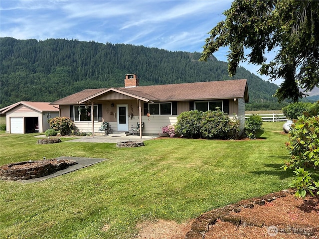 158 Skaggs Rd, Morton, WA 98356 - ranch-style home with a wooded view, a chimney, a garage, and a mountain view