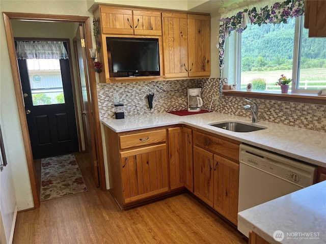 158 Skaggs Rd, Morton, WA 98356 - kitchen with white dishwasher, light wood-style floors, light countertops, and tasteful backsplash
