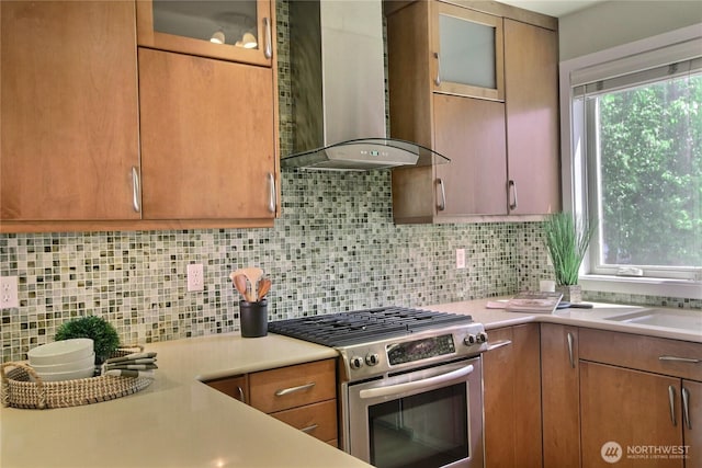 4411 Greenwood Ave N, Seattle, WA 98103 - kitchen with stainless steel gas range oven, wall chimney range hood, light countertops, and backsplash