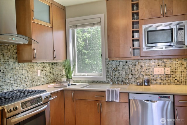 4411 Greenwood Ave N, Seattle, WA 98103 - kitchen featuring stainless steel appliances, wall chimney range hood, light countertops, and decorative backsplash