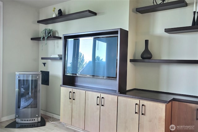4411 Greenwood Ave N, Seattle, WA 98103 - kitchen with open shelves, light brown cabinetry, light wood-style flooring, and dark countertops