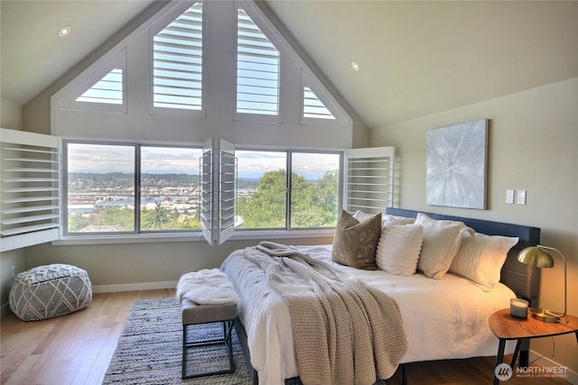 4411 Greenwood Ave N, Seattle, WA 98103 - bedroom featuring high vaulted ceiling, wood finished floors, and recessed lighting