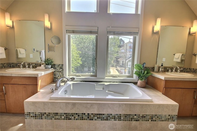 4411 Greenwood Ave N, Seattle, WA 98103 - bathroom featuring tile patterned flooring, two vanities, and a bath