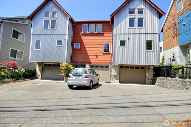 4411 Greenwood Ave N, Seattle, WA 98103 - view of front facade featuring a garage, concrete driveway, and stone siding