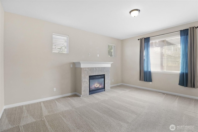 15309 91st Ave SE, Yelm, WA 98597 - unfurnished living room featuring plenty of natural light, a tile fireplace, and carpet flooring