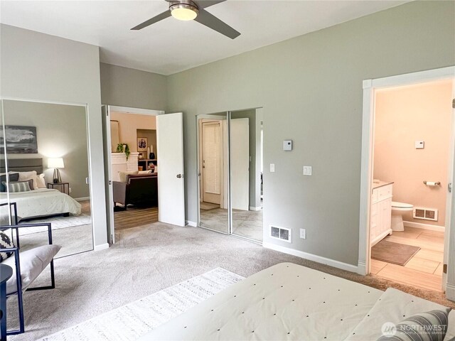 91 N Chandler Ct Unit D, Port Ludlow, WA 98365 - bedroom featuring light carpet, ensuite bathroom, and ceiling fan