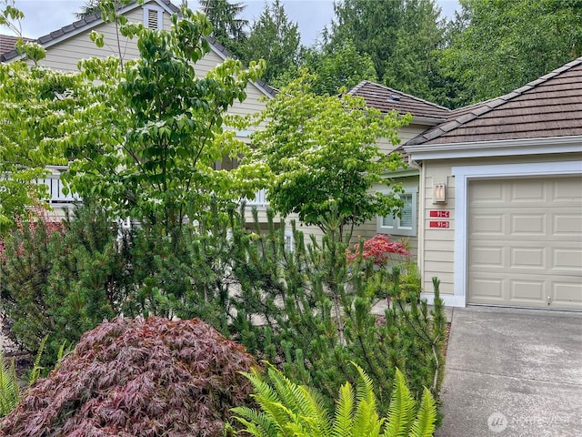 91 N Chandler Ct Unit D, Port Ludlow, WA 98365 - view of home's exterior with a garage and a tiled roof