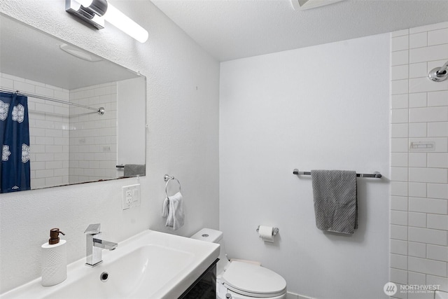 14760 NE 31st St Unit A307, Bellevue, WA 98007 - bathroom featuring a tile shower, vanity, and a textured ceiling
