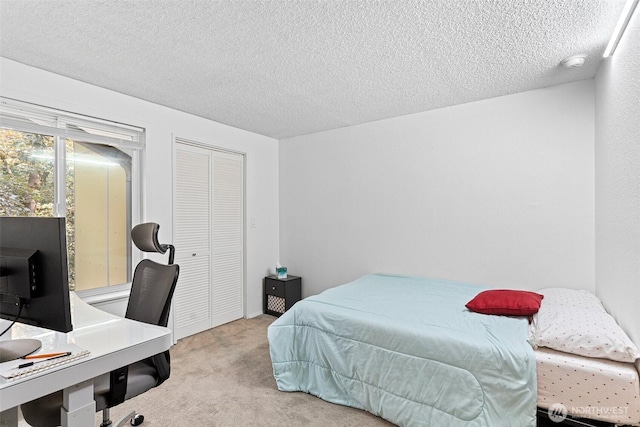 14760 NE 31st St Unit A307, Bellevue, WA 98007 - bedroom with carpet flooring, a textured ceiling, a closet, and a desk