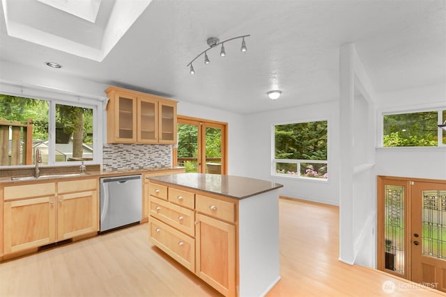 400 Sudden Valley Dr, Bellingham, WA 98229 - kitchen with stainless steel dishwasher, light wood finished floors, light brown cabinets, and a skylight