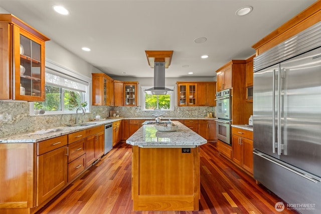 11028 E Riverside Dr, Bothell, WA 98011 - kitchen with appliances with stainless steel finishes, island range hood, a center island, dark wood-style flooring, and recessed lighting