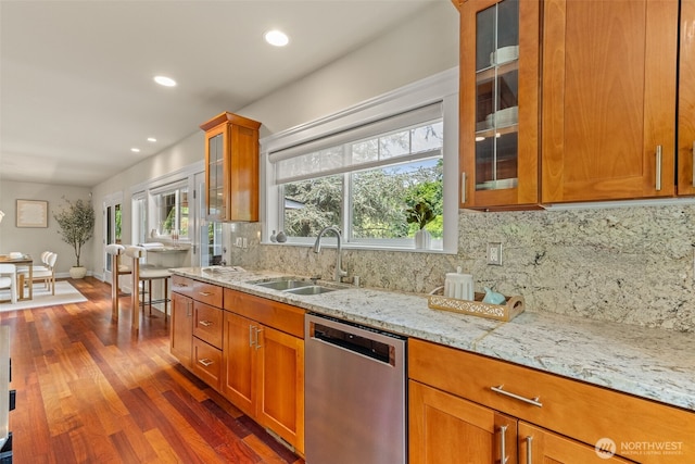 11028 E Riverside Dr, Bothell, WA 98011 - kitchen featuring stainless steel dishwasher, dark wood-style floors, light stone countertops, tasteful backsplash, and brown cabinetry