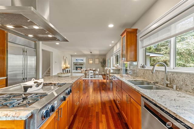 11028 E Riverside Dr, Bothell, WA 98011 - kitchen with range hood, appliances with stainless steel finishes, brown cabinets, dark wood-style flooring, and plenty of natural light