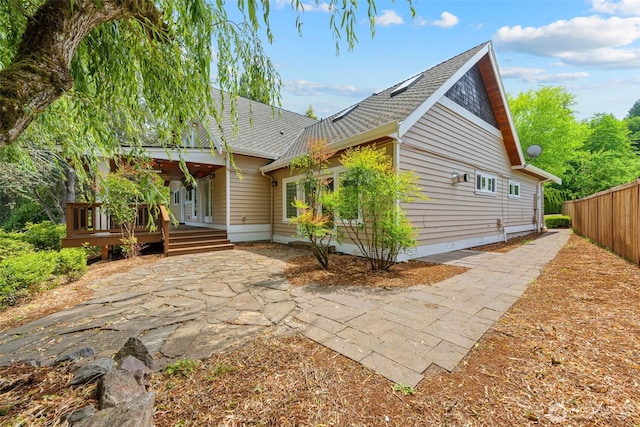 11028 E Riverside Dr, Bothell, WA 98011 - rear view of property featuring a shingled roof, a patio, a deck, and crawl space