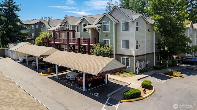 13000 Admiralty Way # D303, Everett, WA 98204 - view of building exterior featuring covered and uncovered parking and a residential view