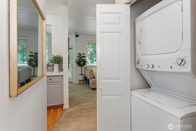 13000 Admiralty Way # D303, Everett, WA 98204 - laundry area featuring stacked washer and clothes dryer and light carpet