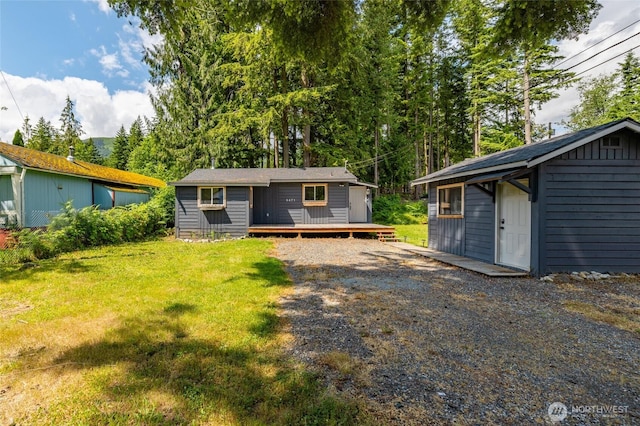 8471 Golden Valley Dr, Maple Falls, WA 98266 - back of house featuring a wooden deck, a yard, and an outbuilding