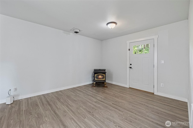 8471 Golden Valley Dr, Maple Falls, WA 98266 - empty room with a wood stove and wood finished floors