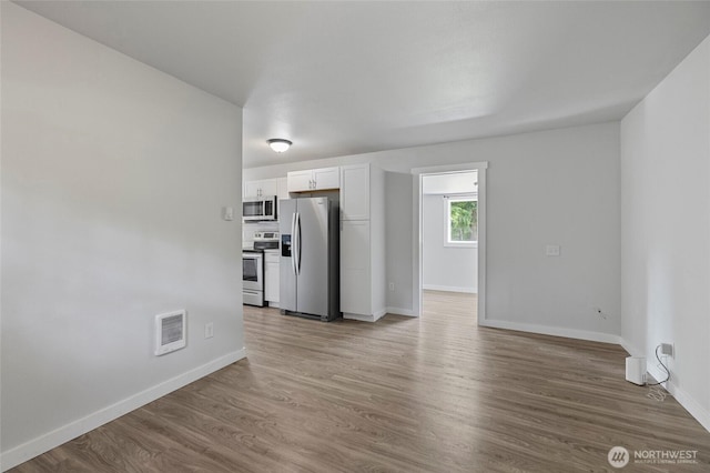 8471 Golden Valley Dr, Maple Falls, WA 98266 - unfurnished living room featuring baseboards and wood finished floors