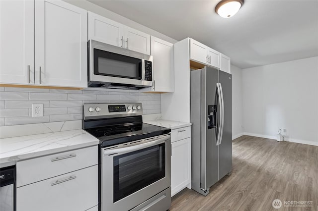8471 Golden Valley Dr, Maple Falls, WA 98266 - kitchen featuring appliances with stainless steel finishes, light wood-style flooring, white cabinetry, and decorative backsplash