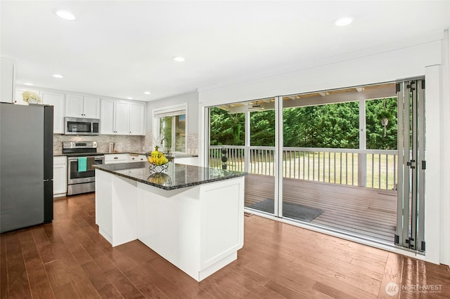 43712 SE 168th St, North Bend, WA 98045 - kitchen with appliances with stainless steel finishes, white cabinetry, dark wood-type flooring, decorative backsplash, and recessed lighting