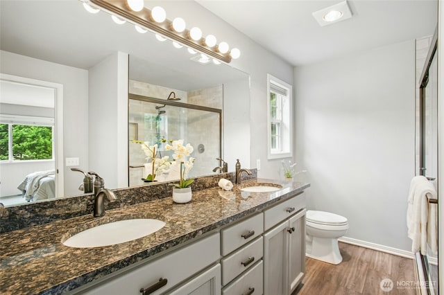 43712 SE 168th St, North Bend, WA 98045 - ensuite bathroom featuring double vanity, a stall shower, and wood finished floors