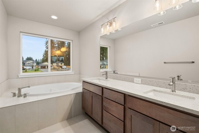 2883 74th Ln SW Unit Lot105, Tumwater, WA 98512 - full bath with a garden tub, double vanity, recessed lighting, and tile patterned floors