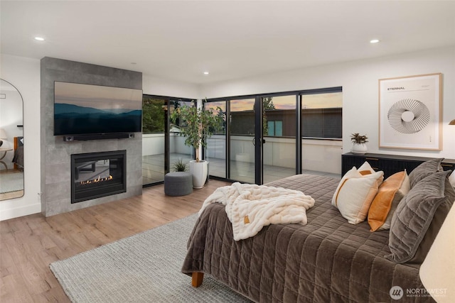 7826 115th Pl NE, Kirkland, WA 98033 - bedroom featuring wood finished floors, recessed lighting, and a tile fireplace