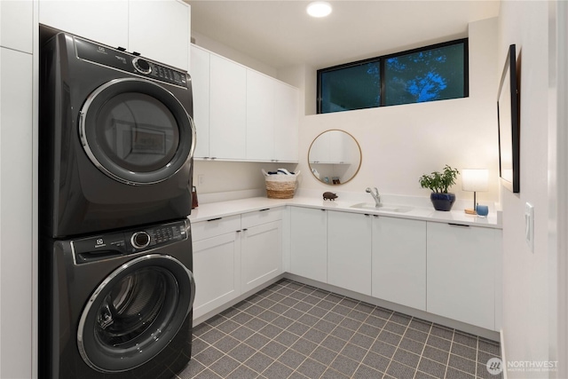 7826 115th Pl NE, Kirkland, WA 98033 - laundry room featuring stacked washer / drying machine, cabinet space, and tile patterned floors
