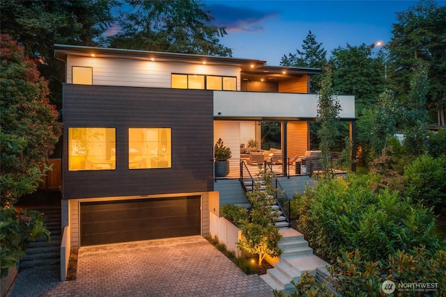 7826 115th Pl NE, Kirkland, WA 98033 - contemporary house with stairs, a garage, and decorative driveway