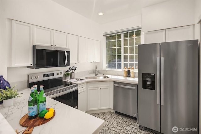 1900 132nd Ave SE Unit I-23, Bellevue, WA 98005 - kitchen with stainless steel appliances, light countertops, white cabinetry, and recessed lighting