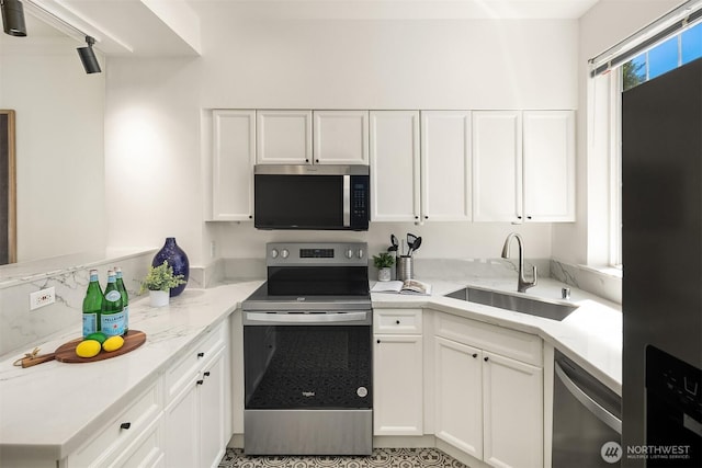 1900 132nd Ave SE Unit I-23, Bellevue, WA 98005 - kitchen with stainless steel appliances, white cabinets, light stone countertops, and a peninsula