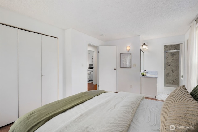 2012 SE 18th Ct, Renton, WA 98055 - bedroom featuring a closet, a textured ceiling, and wood finished floors