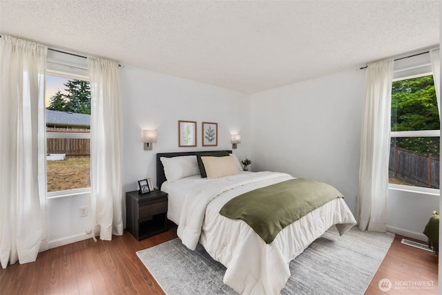 2012 SE 18th Ct, Renton, WA 98055 - bedroom with wood finished floors and a textured ceiling