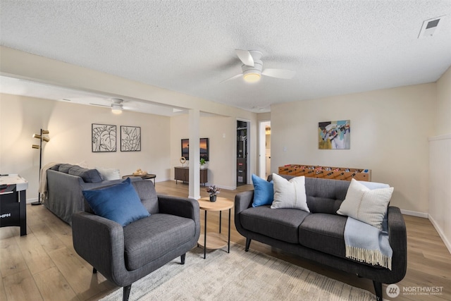 2012 SE 18th Ct, Renton, WA 98055 - living room with ceiling fan, light wood-style flooring, and a textured ceiling