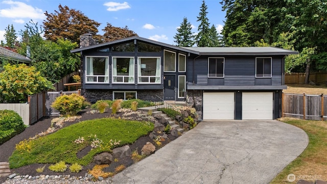 2012 SE 18th Ct, Renton, WA 98055 - raised ranch with a garage, driveway, a chimney, and stone siding