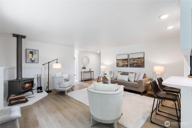 1708 24th Ct, Anacortes, WA 98221 - living room with light wood-style flooring, a wood stove, and recessed lighting