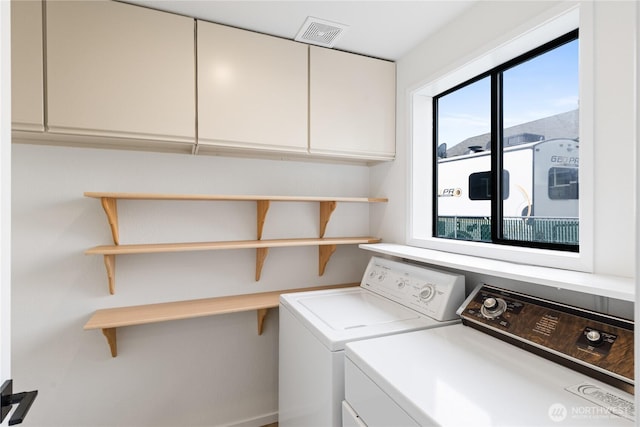 1708 24th Ct, Anacortes, WA 98221 - washroom with separate washer and dryer, cabinet space, and plenty of natural light