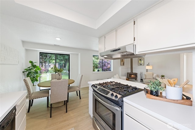 1708 24th Ct, Anacortes, WA 98221 - kitchen featuring stainless steel range with gas cooktop, under cabinet range hood, light countertops, light wood-style flooring, and recessed lighting