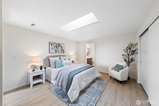1708 24th Ct, Anacortes, WA 98221 - bedroom with a skylight, light wood-style floors, a closet, and connected bathroom