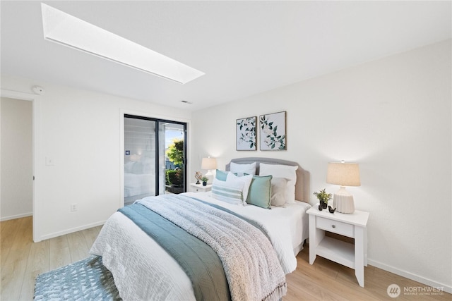 1708 24th Ct, Anacortes, WA 98221 - bedroom with a skylight, light wood finished floors, and access to exterior