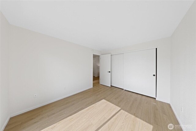 1708 24th Ct, Anacortes, WA 98221 - unfurnished bedroom featuring wood finished floors and a closet