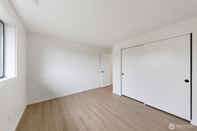 1708 24th Ct, Anacortes, WA 98221 - unfurnished bedroom featuring light wood-style flooring and a closet
