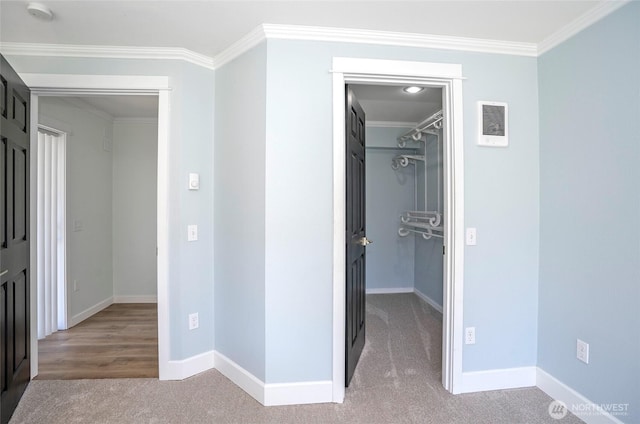 15512 Elm St E, Sumner, WA 98390 - unfurnished bedroom with a walk in closet, crown molding, a closet, and carpet floors