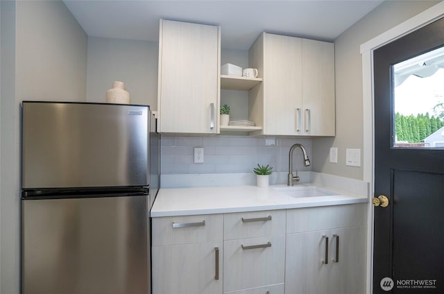 15512 Elm St E, Sumner, WA 98390 - kitchen with freestanding refrigerator, open shelves, light countertops, and backsplash
